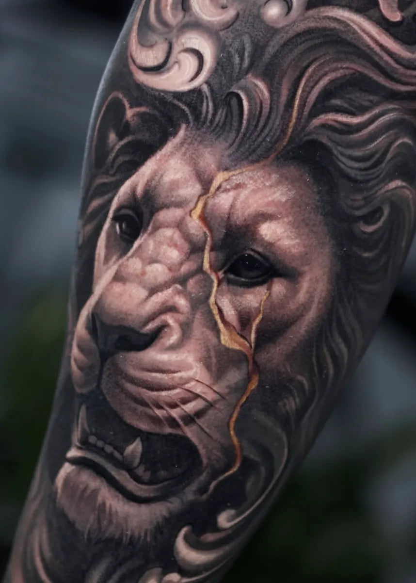 Black and grey realistic lion tattoo by Adrian Rod
