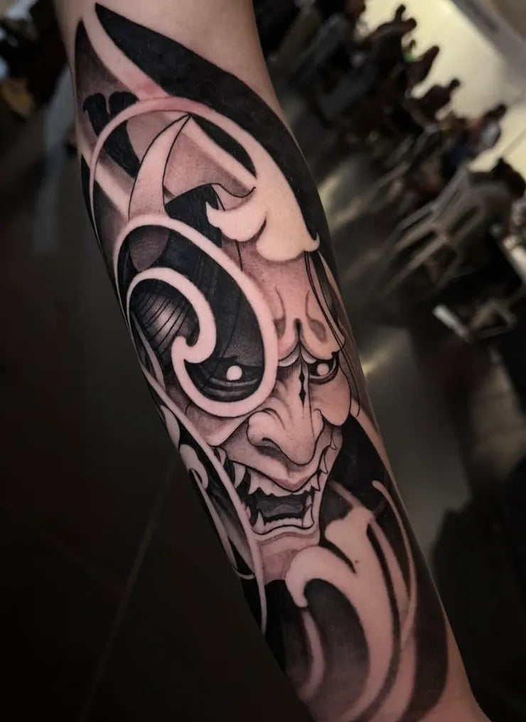 Black and grey Japanese hannya mask tattoo by Arantxa Encinas